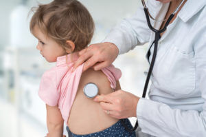 Pediatrician doctor examining a child