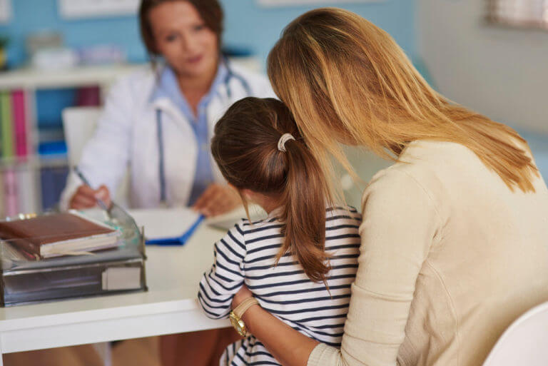 An image depicting a pediatrician with a mother and her child, who visited the clinic for a pediatric physical examination.